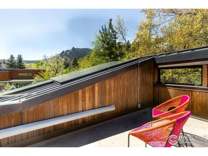 a wooden bench sitting in front of a building