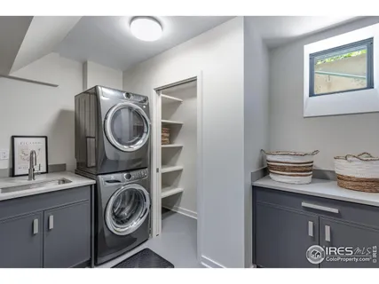 a kitchen that has a sink a stove and cabinets