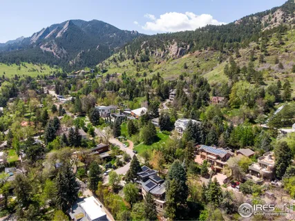 a view of a houses with a lush green hillside
