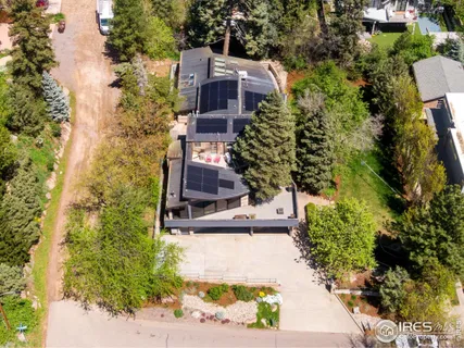 an aerial view of a house with a yard basket ball court and outdoor seating