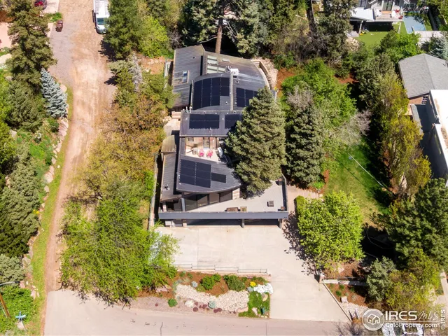 an aerial view of a house with a yard basket ball court and outdoor seating