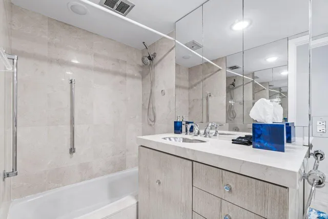 a bathroom with a sink double vanity and a bathtub