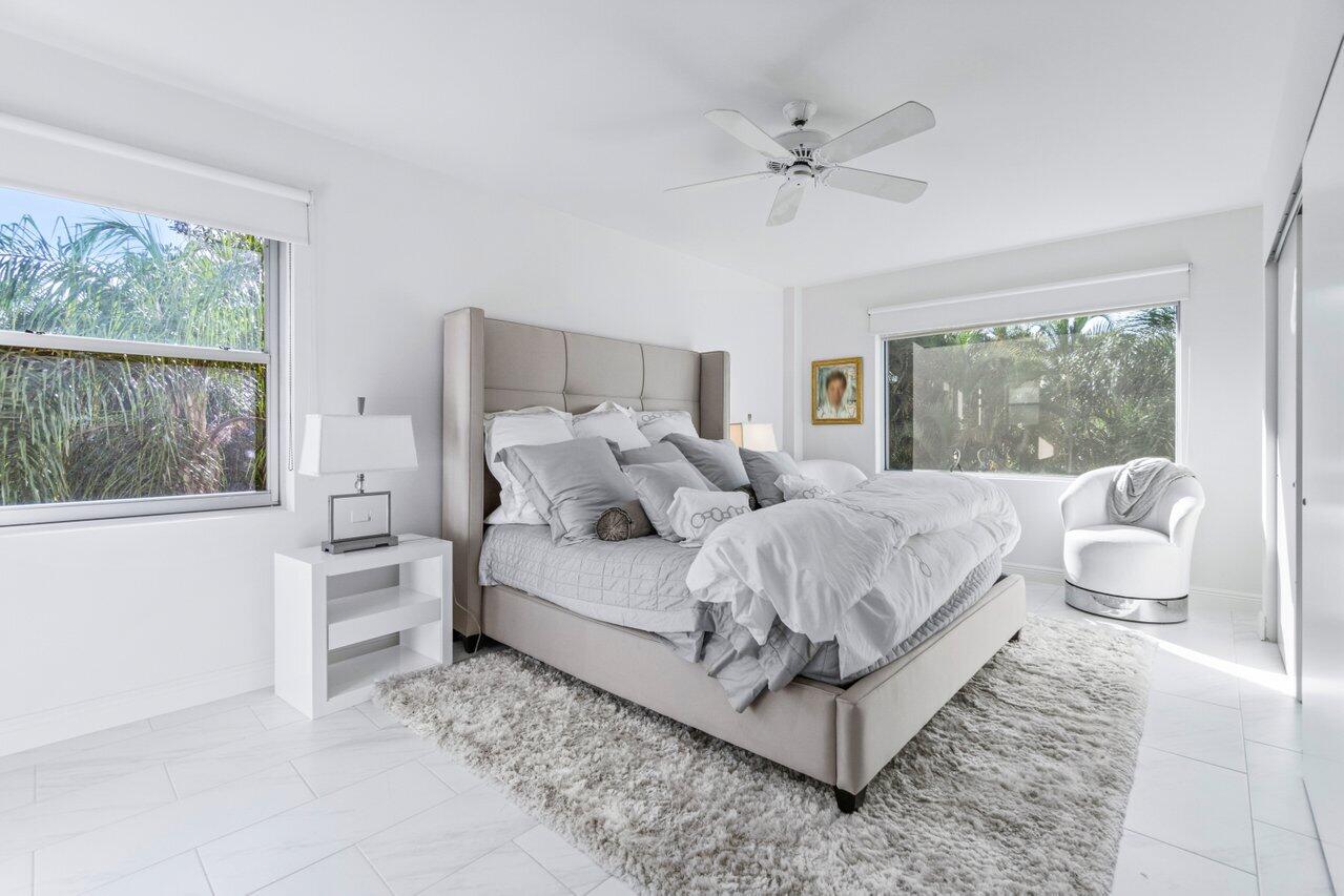 44 Cocoanut Row, Unit 120B Palm Beach, FL 33480 - Photo 17 of 51 a bed room with a bed and a large window