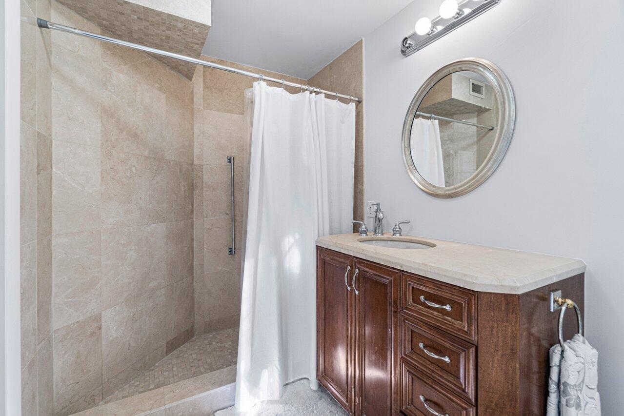 44 Cocoanut Row, Unit 120B Palm Beach, FL 33480 - Photo 20 of 51 a bathroom with a sink and a mirror