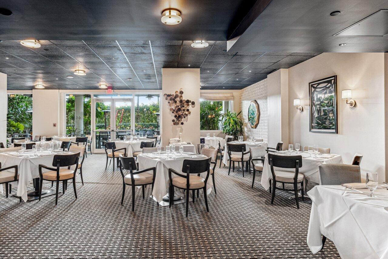 44 Cocoanut Row, Unit 120B Palm Beach, FL 33480 - Photo 28 of 51 a room with lots of tables a large window and chairs