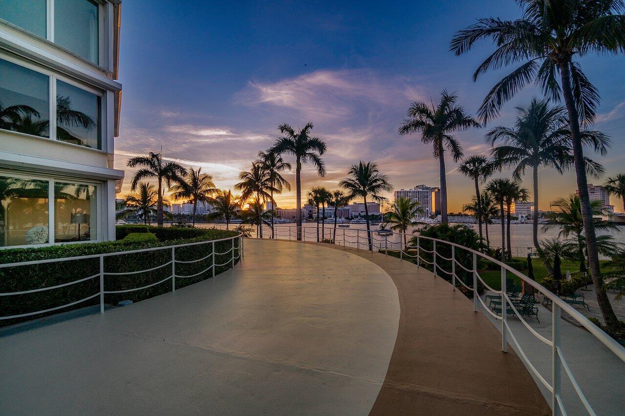 44 Cocoanut Row, Unit 120B Palm Beach, FL 33480 - Photo 40 of 51 a view of a swimming pool with a table and chairs