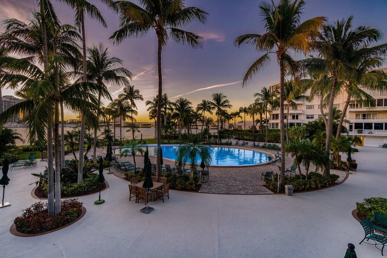 44 Cocoanut Row, Unit 120B Palm Beach, FL 33480 - Photo 41 of 51 a view of a patio with a table and chairs under an umbrella