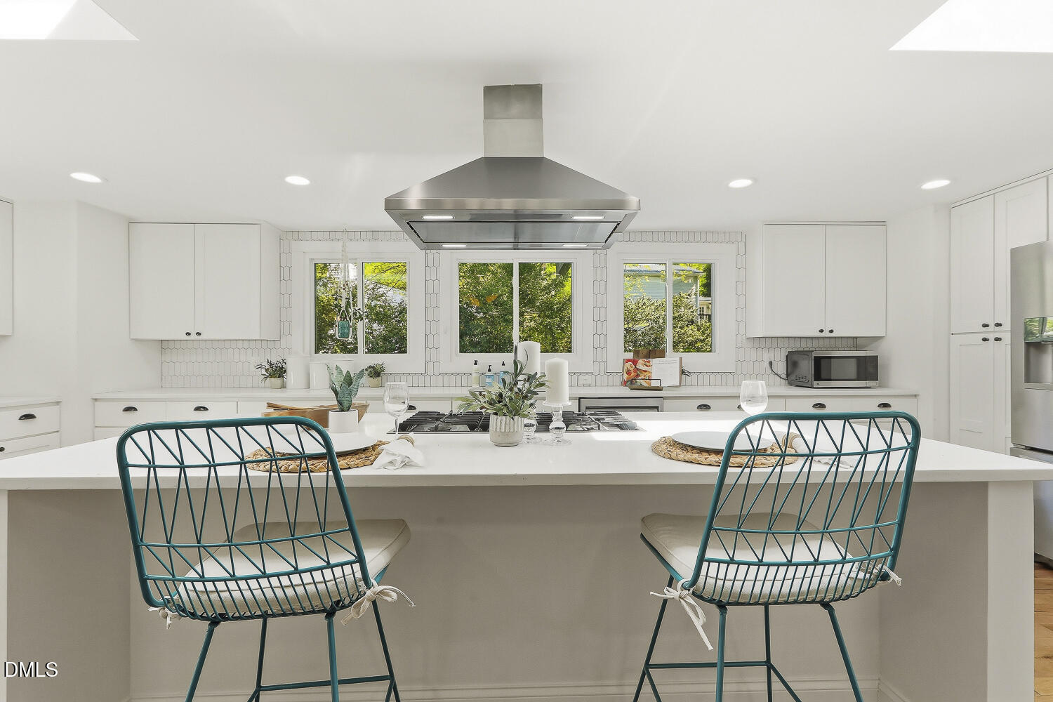 3704 Swann Street Raleigh, NC 27612 - Photo 5 of 21 a kitchen with a table chairs and a view of living room