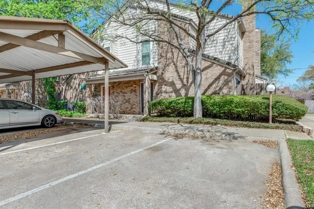 a view of a street with a car parked on the road