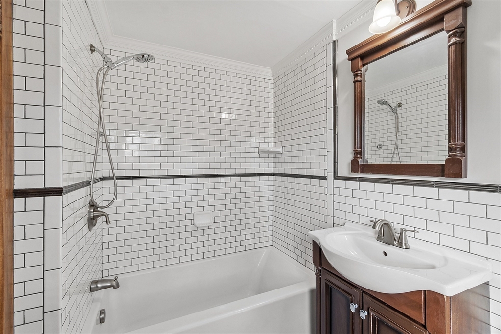 42 Stevens Street, Unit 42 Andover, MA 01810 - Photo 12 of 19 a bathroom with a sink a mirror and a bathtub