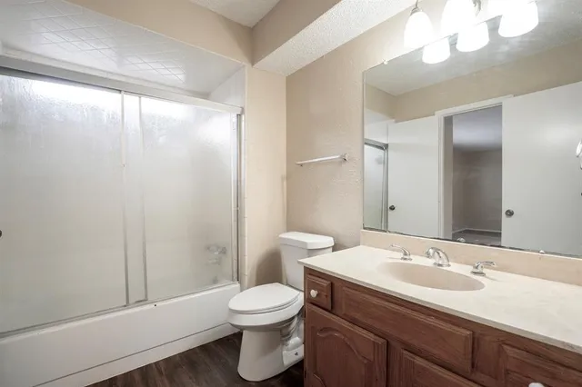 a bathroom with a toilet a sink and a large mirror