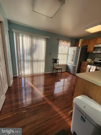 a view of a livingroom with furniture wooden floor and a window