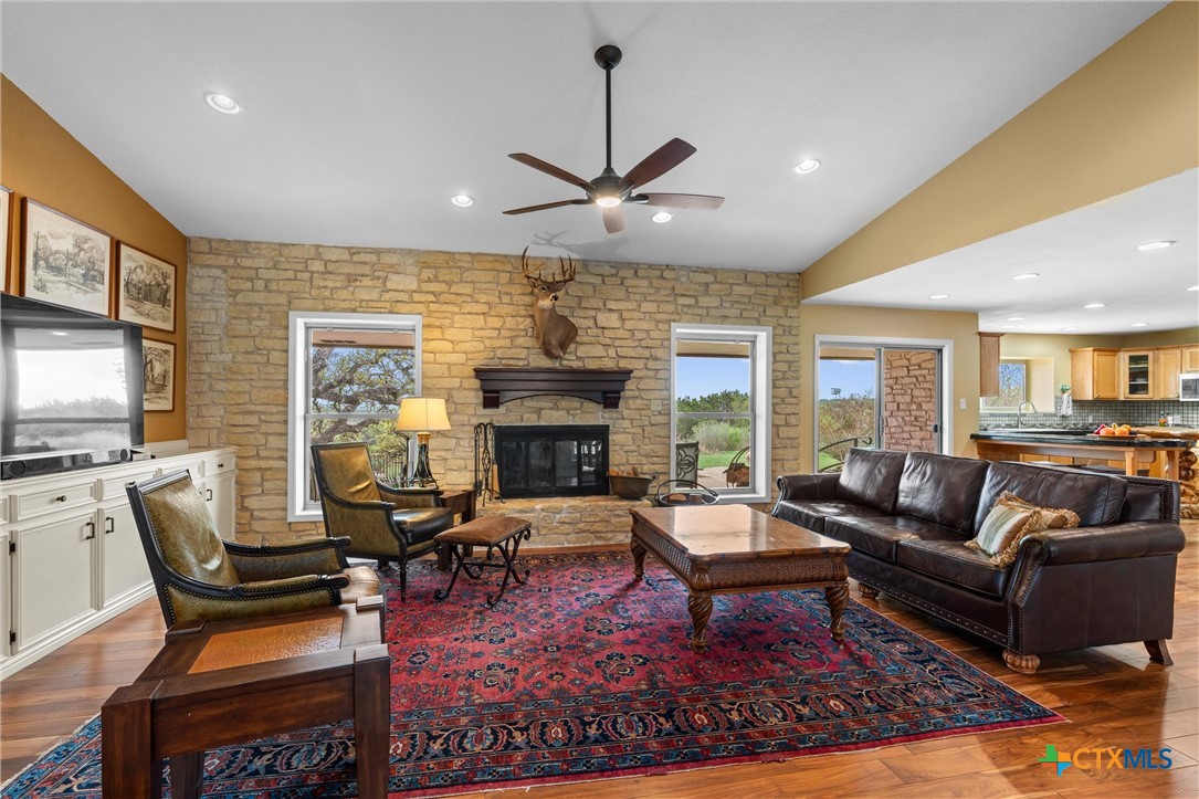 404 Skyline Road Georgetown, TX 78628 - Photo 12 of 40 a living room with furniture a fireplace and a flat screen tv