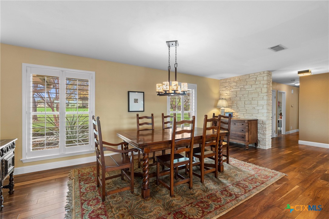 404 Skyline Road Georgetown, TX 78628 - Photo 13 of 40 a view of a dining room with furniture window and wooden floor