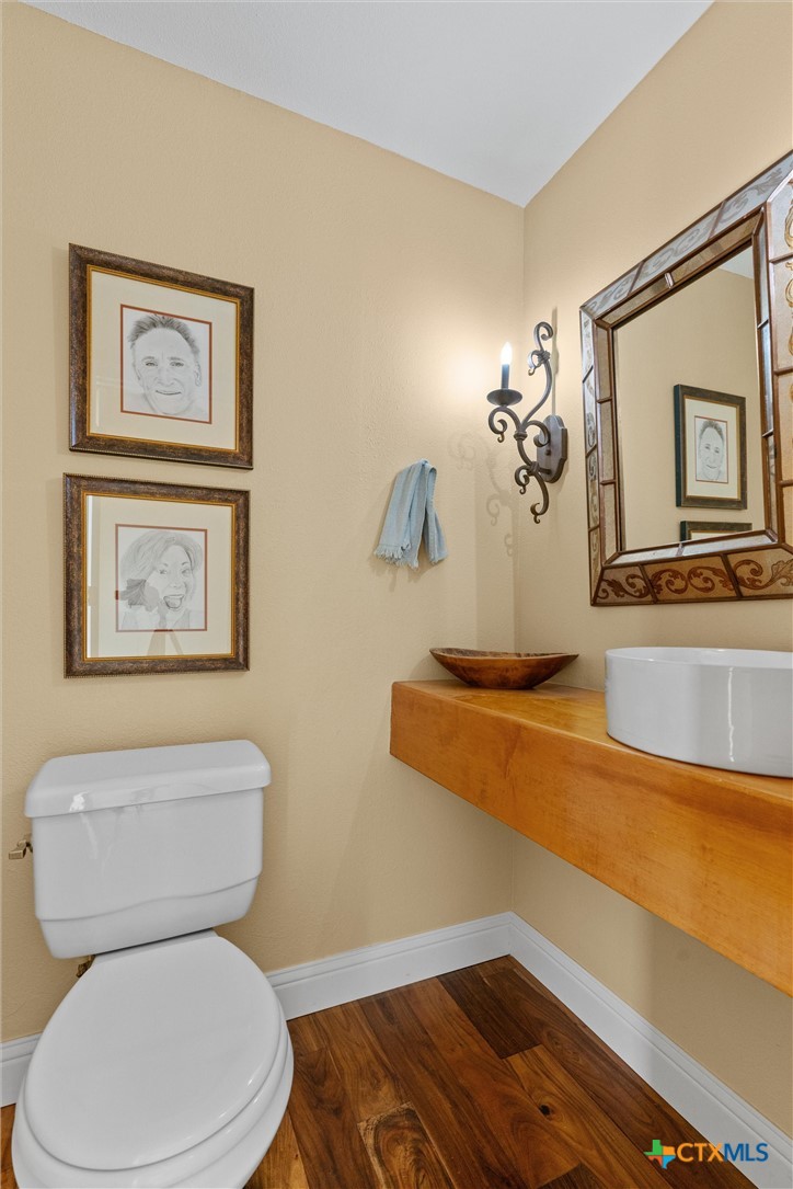 404 Skyline Road Georgetown, TX 78628 - Photo 16 of 40 a bathroom with a toilet and a mirror
