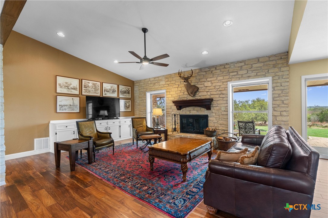 404 Skyline Road Georgetown, TX 78628 - Photo 2 of 40 a living room with furniture a flat screen tv and a fireplace