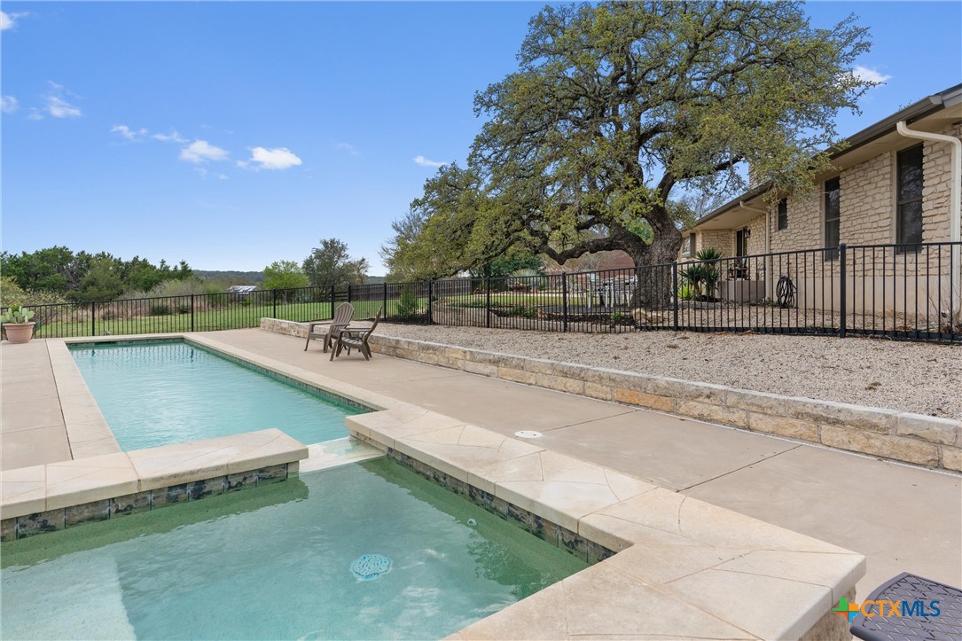404 Skyline Road Georgetown, TX 78628 - Photo 30 of 40 a view of a swimming pool with a patio and a yard
