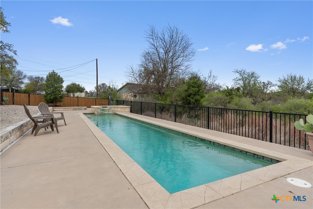 404 Skyline Road Georgetown, TX 78628 - Photo 31 of 40 a view of a swimming pool with a lake view
