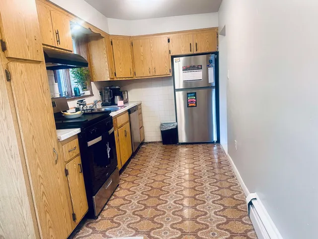 a kitchen with a sink stove and refrigerator