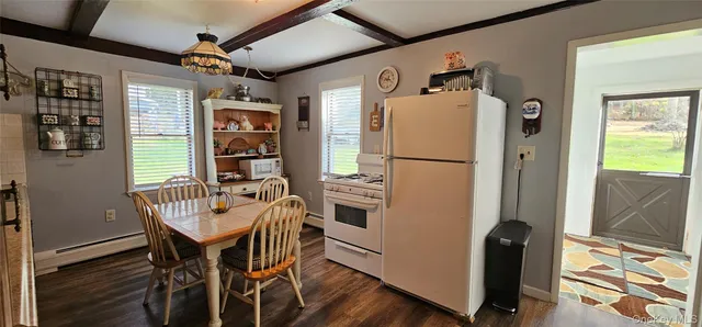 a kitchen with stainless steel appliances granite countertop a refrigerator and a dining table