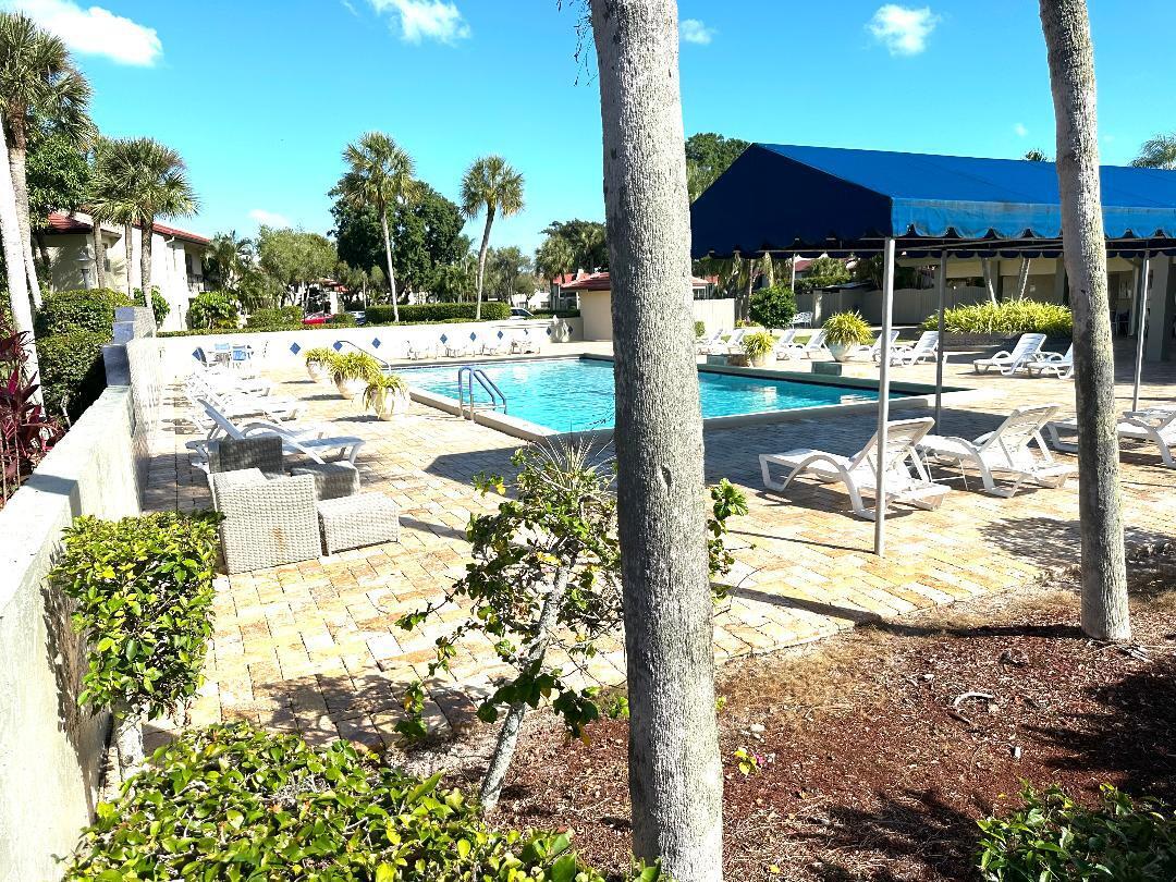 8305 Casa Del Lago, Unit E Boca Raton, FL 33433 - Photo 15 of 16 a view of a swimming pool with a patio