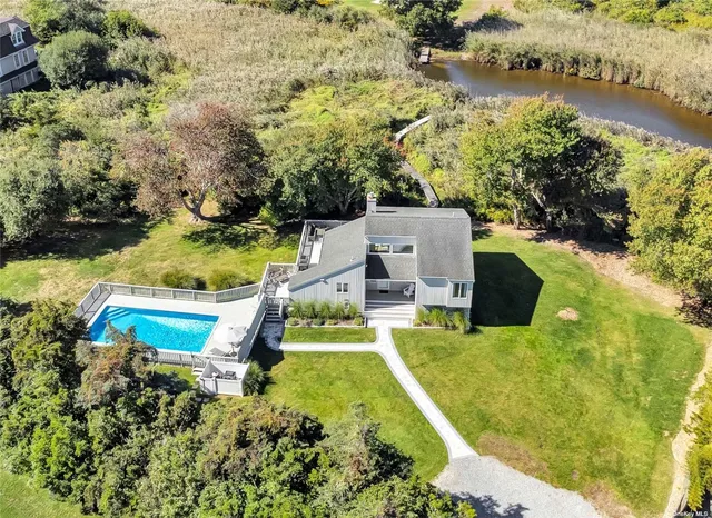 an aerial view of a house with outdoor space lake view