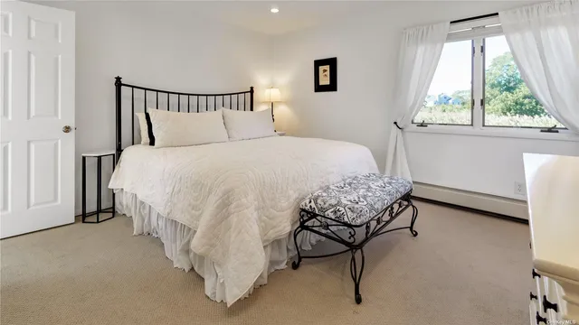 a large bed sitting in a bedroom next to a window