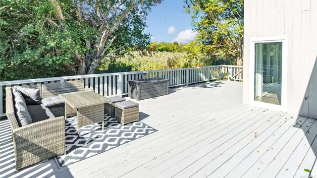 a view of balcony with wooden floor