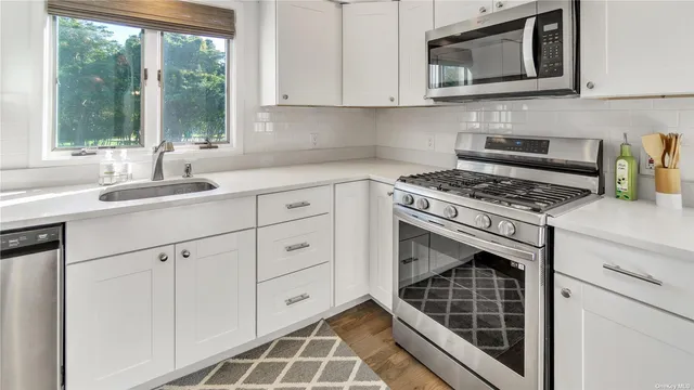 a kitchen with cabinets appliances and a sink