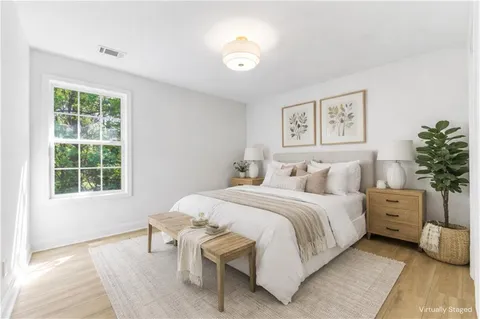 a bedroom with a bed and a large window