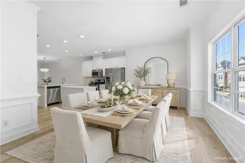 a kitchen with stainless steel appliances granite countertop grey cabinets a stove a sink and dishwasher