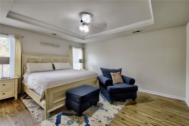 a bedroom with a bed and wooden floor