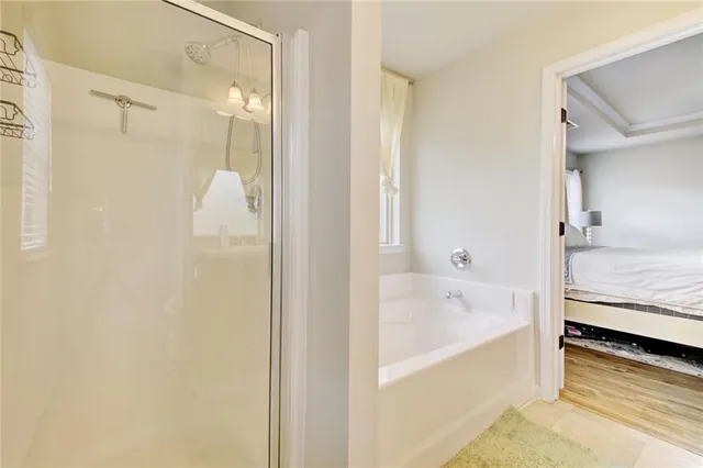 a bathroom with a tub and a shower