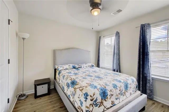 a bedroom with a bed and wooden floor