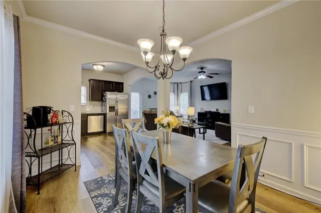 a view of a dining room with furniture and wooden floor