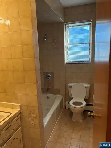 a bathroom with a toilet and a bathtub