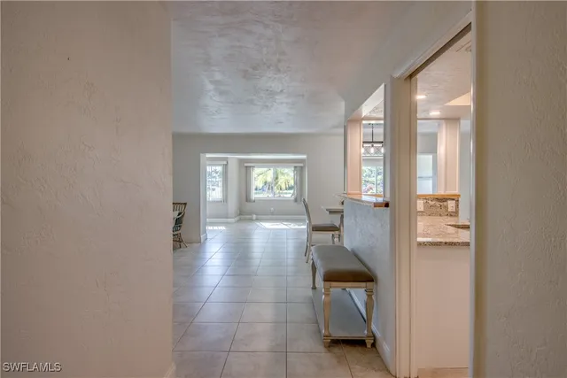 a hallway with a dining table and chairs