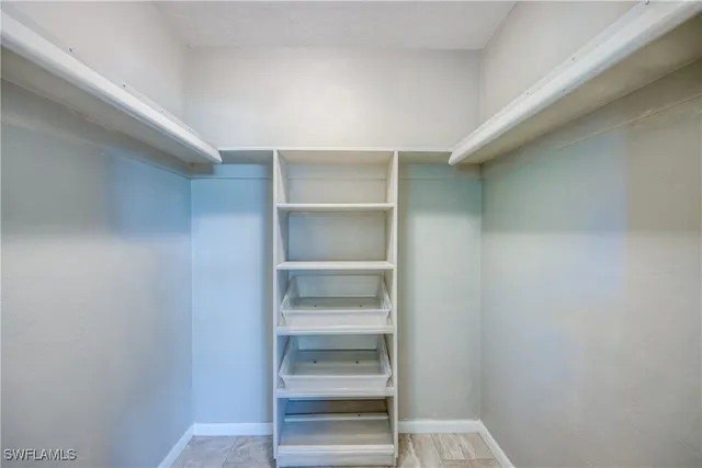 a view of walk in closet with empty racks
