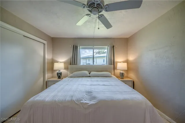 a bedroom with a large bed and a window