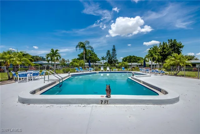 a view of swimming pool with outdoor seating and yard in back