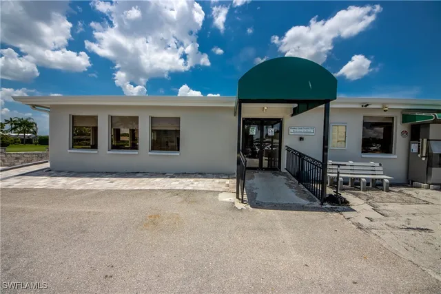 a view of a house with a patio and a yard