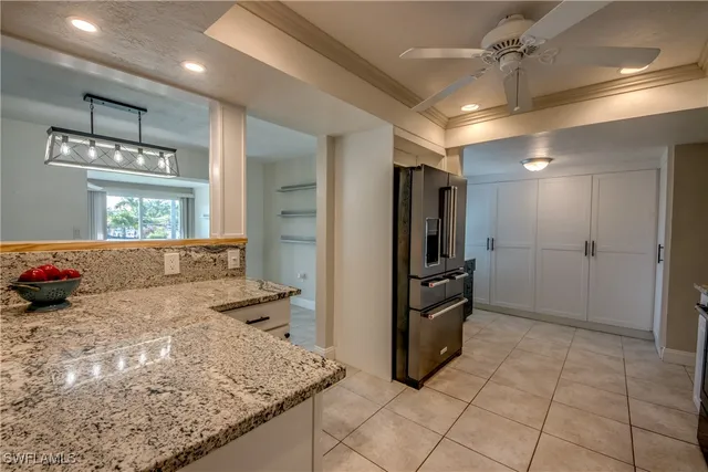 a kitchen with stainless steel appliances granite countertop a refrigerator and a sink
