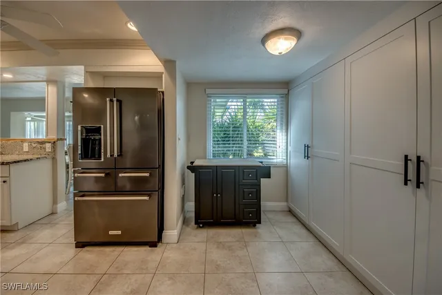 a kitchen with granite countertop a refrigerator and a stove