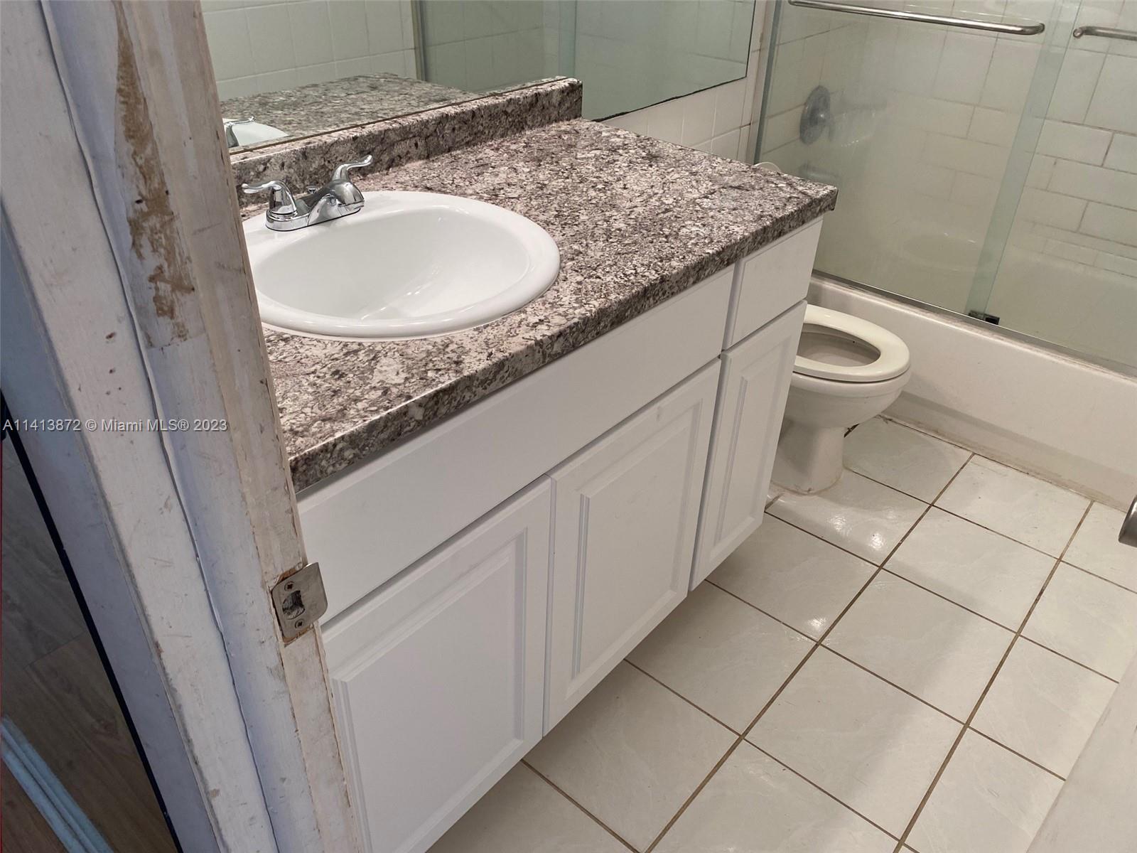 3141 C Road Loxahatchee, FL 33470 - Photo 11 of 16 a bathroom with a granite countertop sink and a toilet