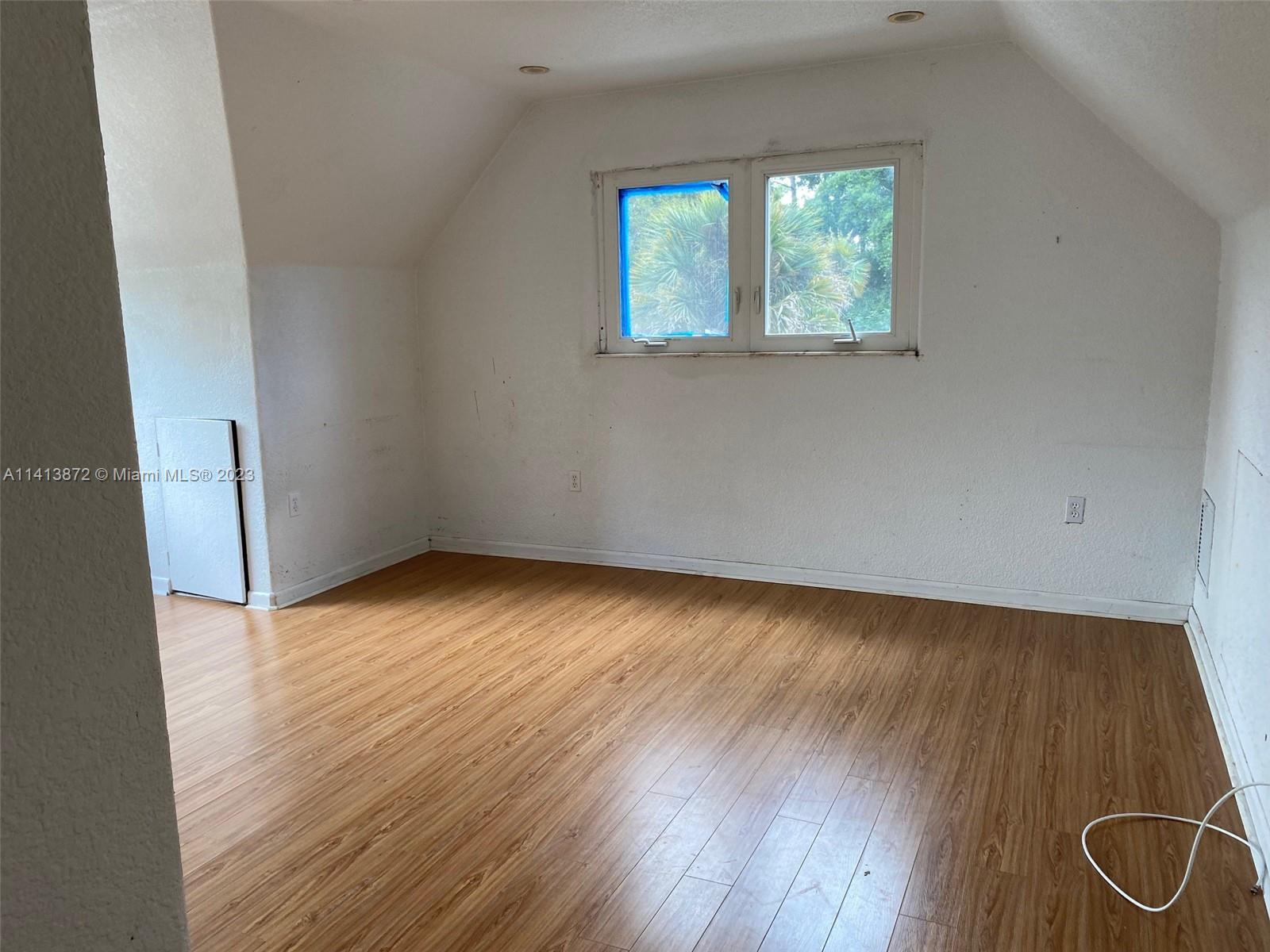 3141 C Road Loxahatchee, FL 33470 - Photo 12 of 16 an empty room with wooden floor and windows