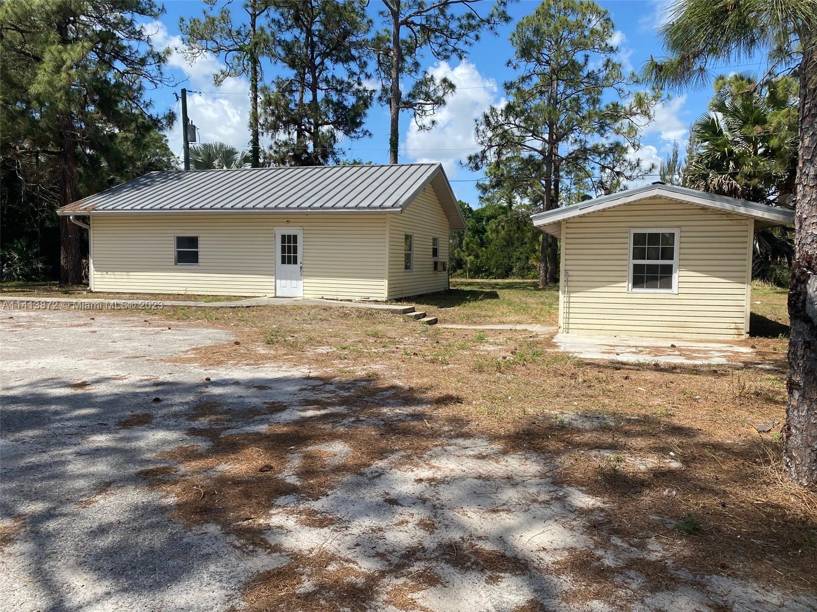 3141 C Road Loxahatchee, FL 33470 - Photo 3 of 16 a house that has a tree in front of it