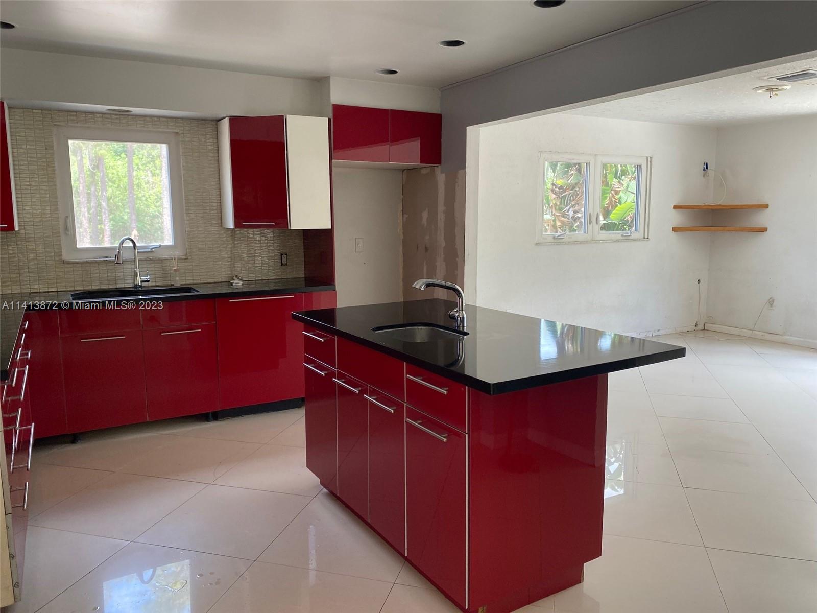 3141 C Road Loxahatchee, FL 33470 - Photo 8 of 16 a kitchen with stainless steel appliances granite countertop a sink and a wooden cabinets