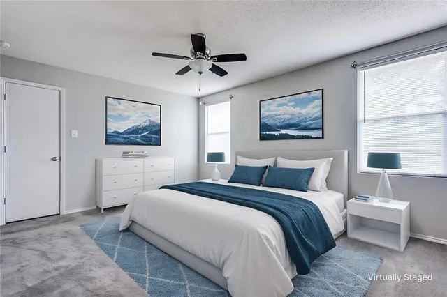 a bedroom with a bed and a painting on the wall