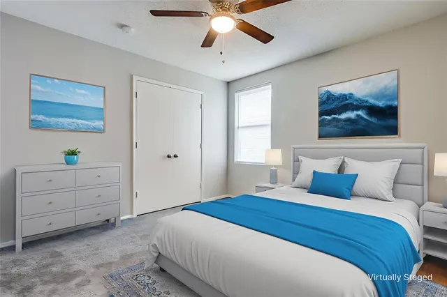 a bedroom with a bed and a ceiling fan