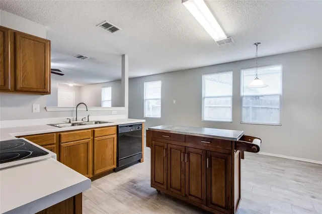 a kitchen with stainless steel appliances granite countertop a sink stove and cabinets